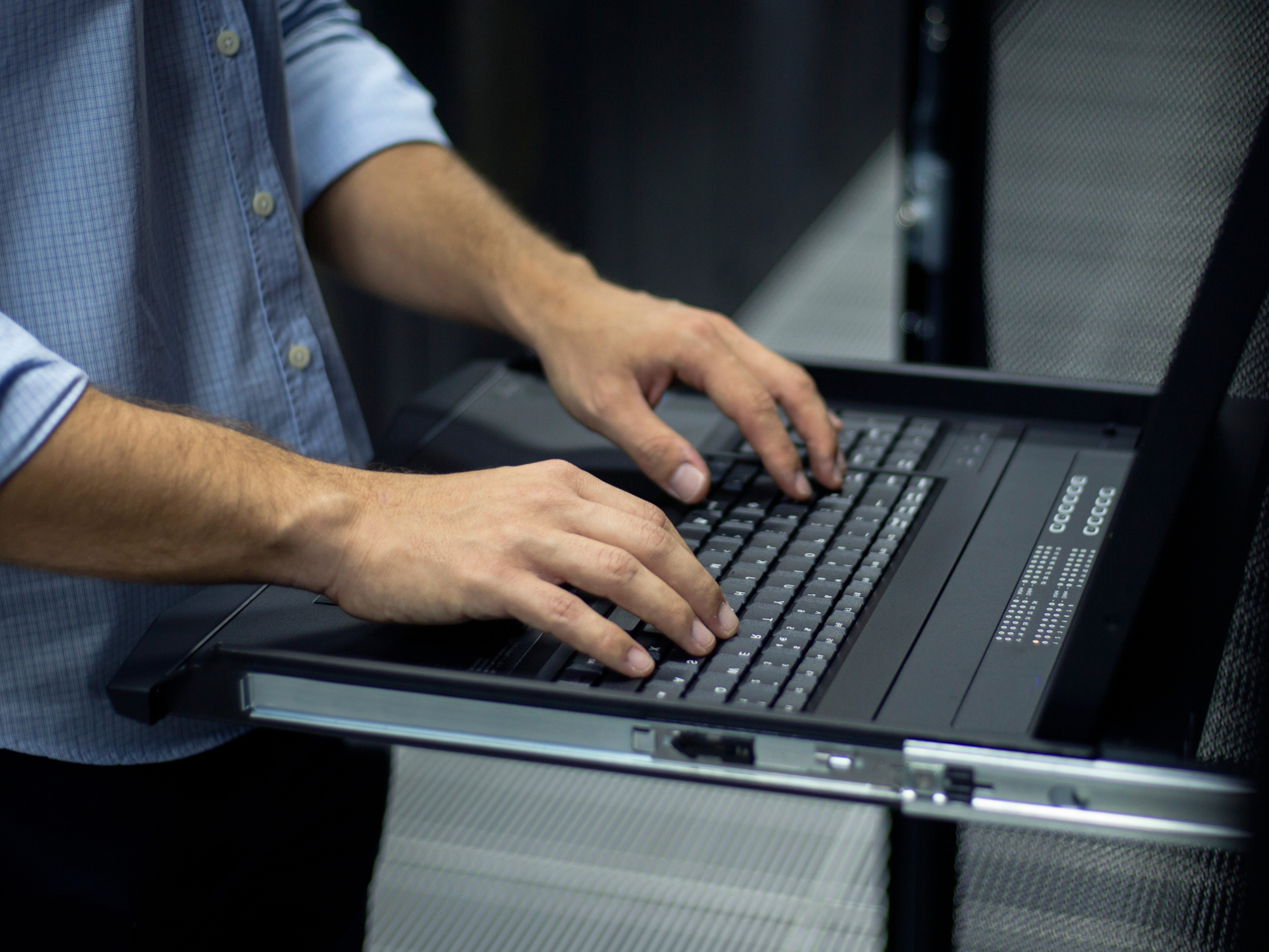 IT technician working on a laptop, providing managed IT support for a growing UK business.