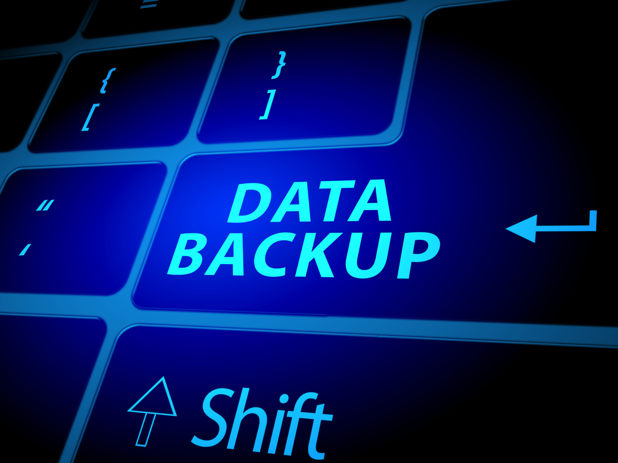 Blue-lit keyboard with a ‘Data Backup’ key, illustrating business data backup and disaster recovery.