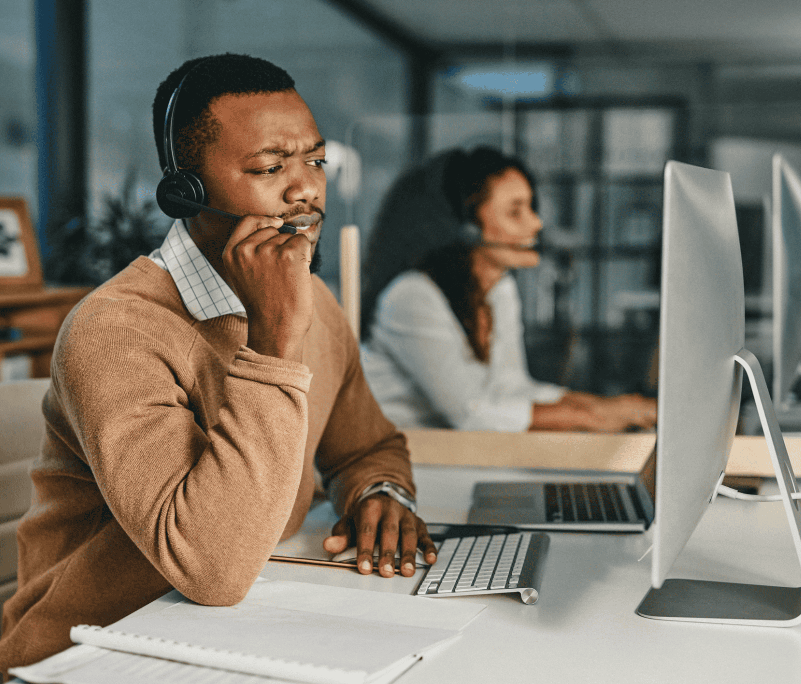 Customer service team members wearing headsets and managing inbound calls in an office environment